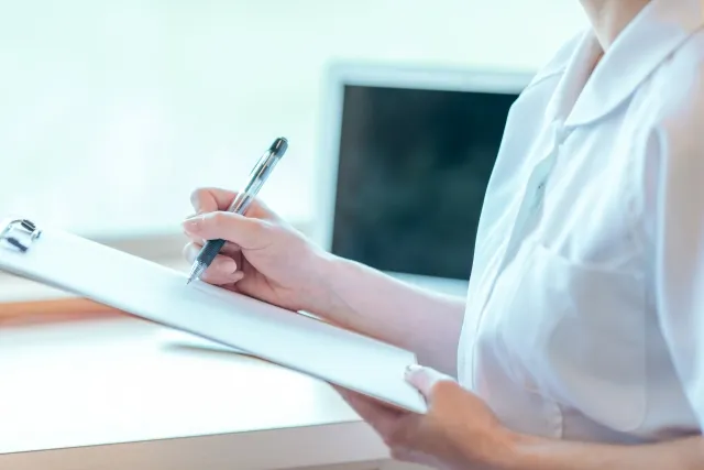 カウンセリングシートに書き込む女性の画像